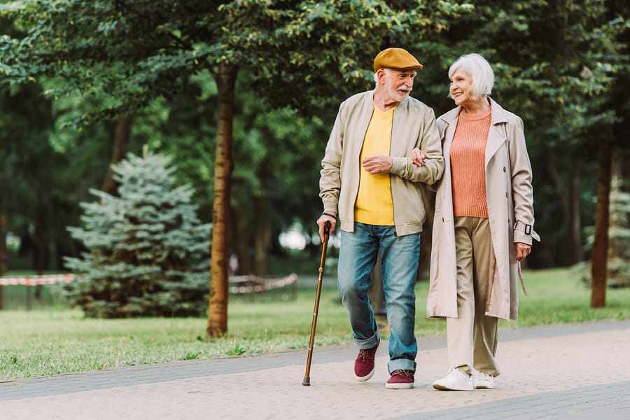 Preventing Falls in older people post - elderly couple walking arm in arm