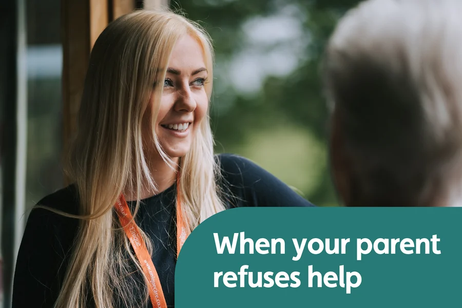 A Unique Senior Care Caregiver talking with an older person at home.