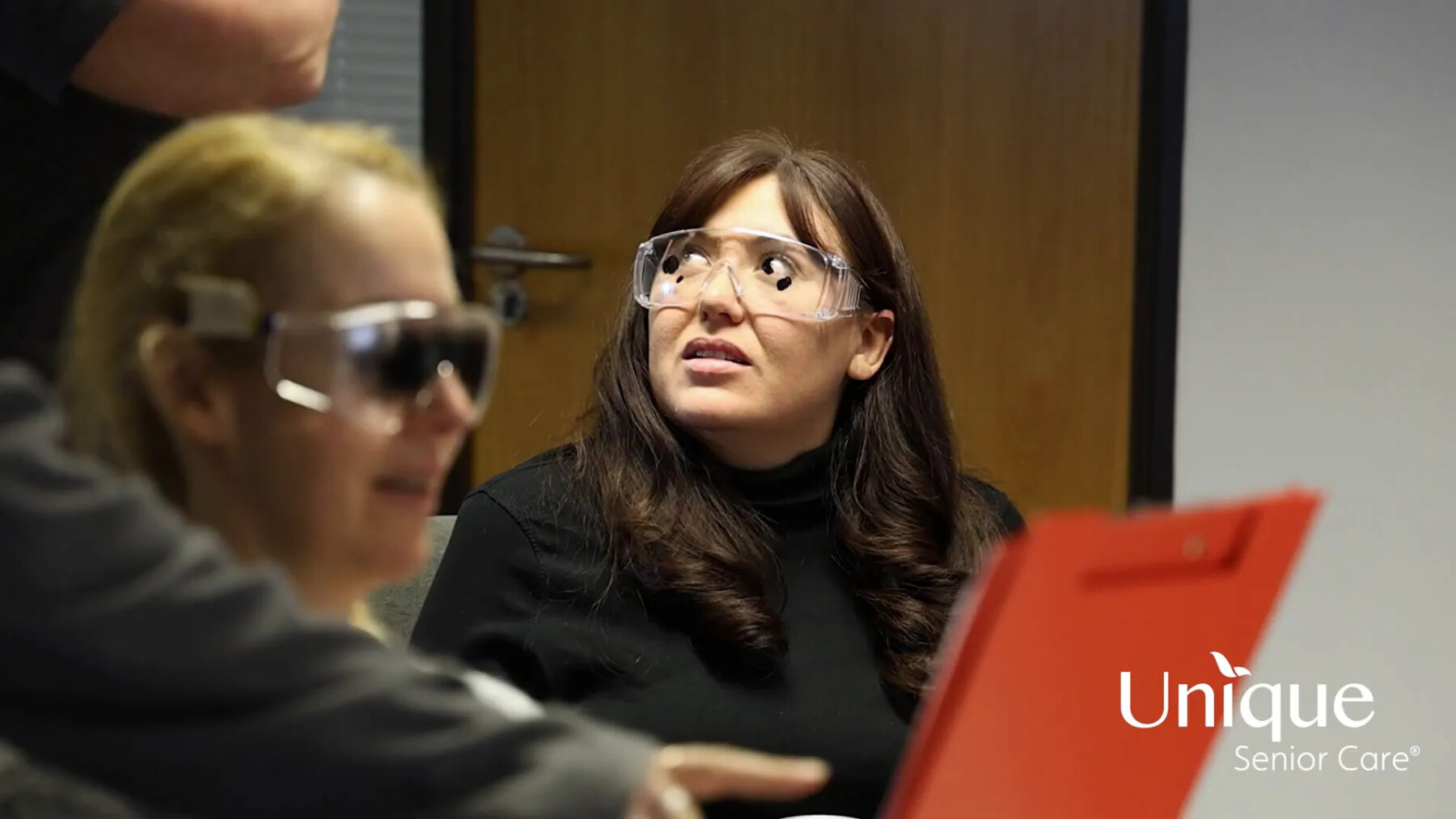 Caregivers participating in practical exercises with simulation specs