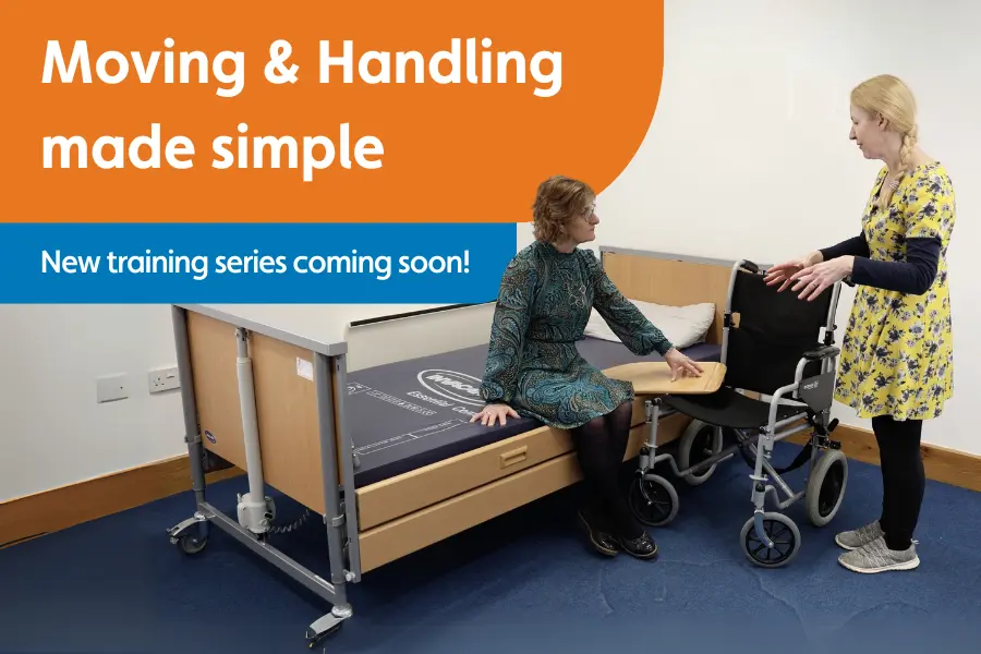Learning and development manager, jo cleary, stood demonstrating moving and handling with her assistant sat on a profiling bed