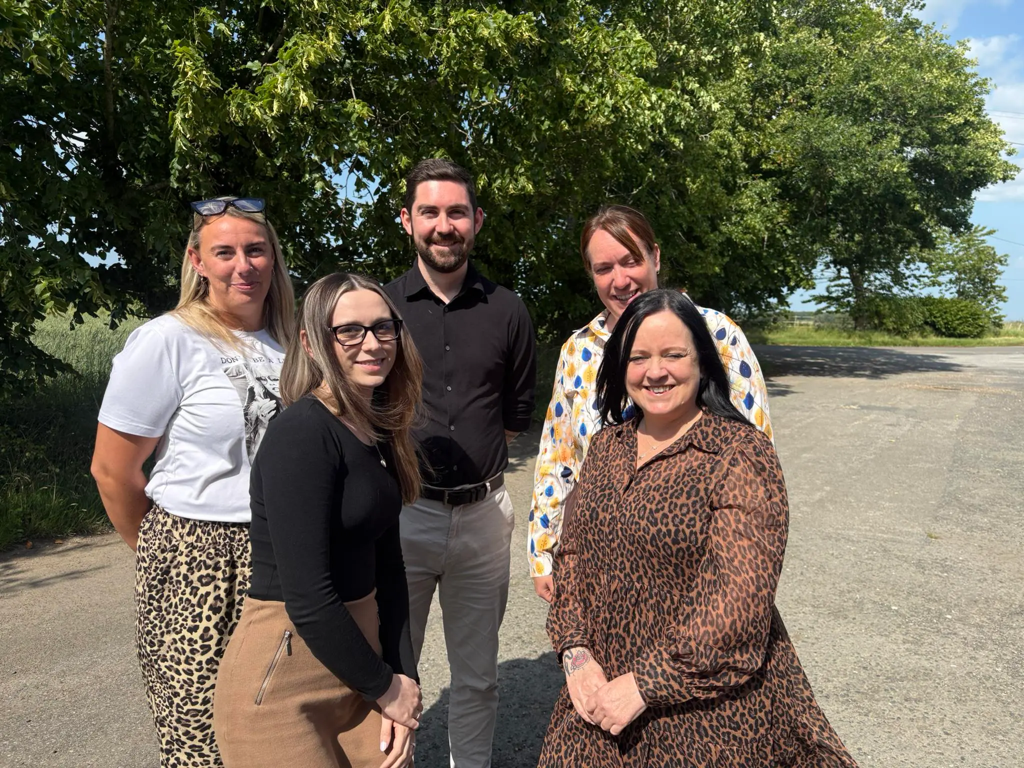 Helena stood with a group of managers