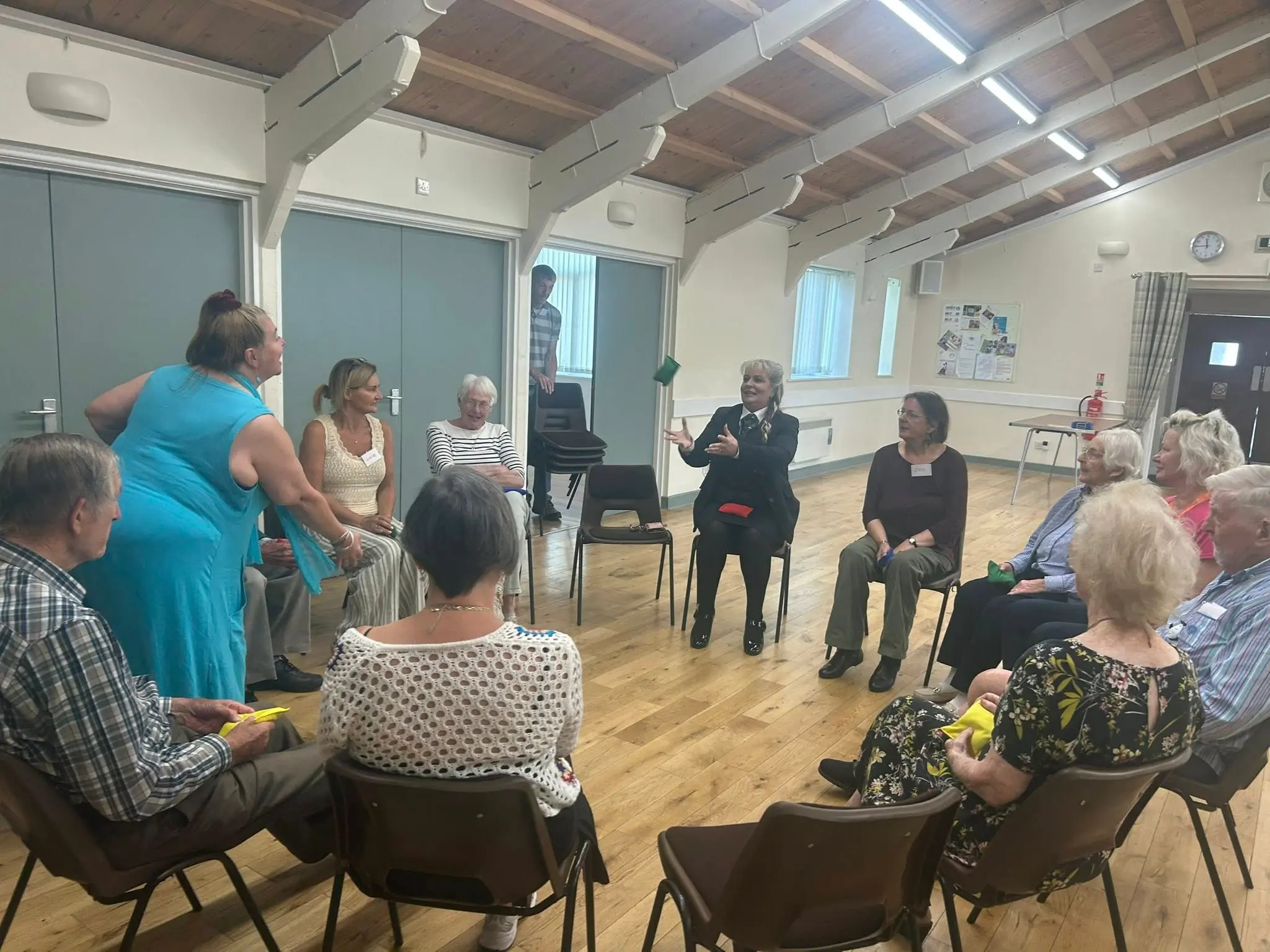 Attendees sat ina circle for an actiuvity at the leamington spa and kenilworth memory cafe