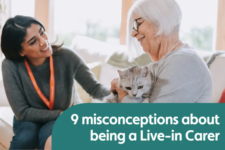 Featured image for blog around misconceptions about being a live in carer. Image shows an elderly lady sat next to her live in carer on the sofa while stroking her cat