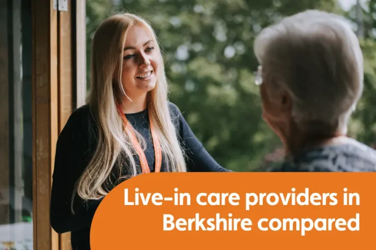 Featured mage for blog comparing ive-in care providers in berkshire. Images shows a young carer stood by awindow chatting to and older leady, both holding a cup of tea.