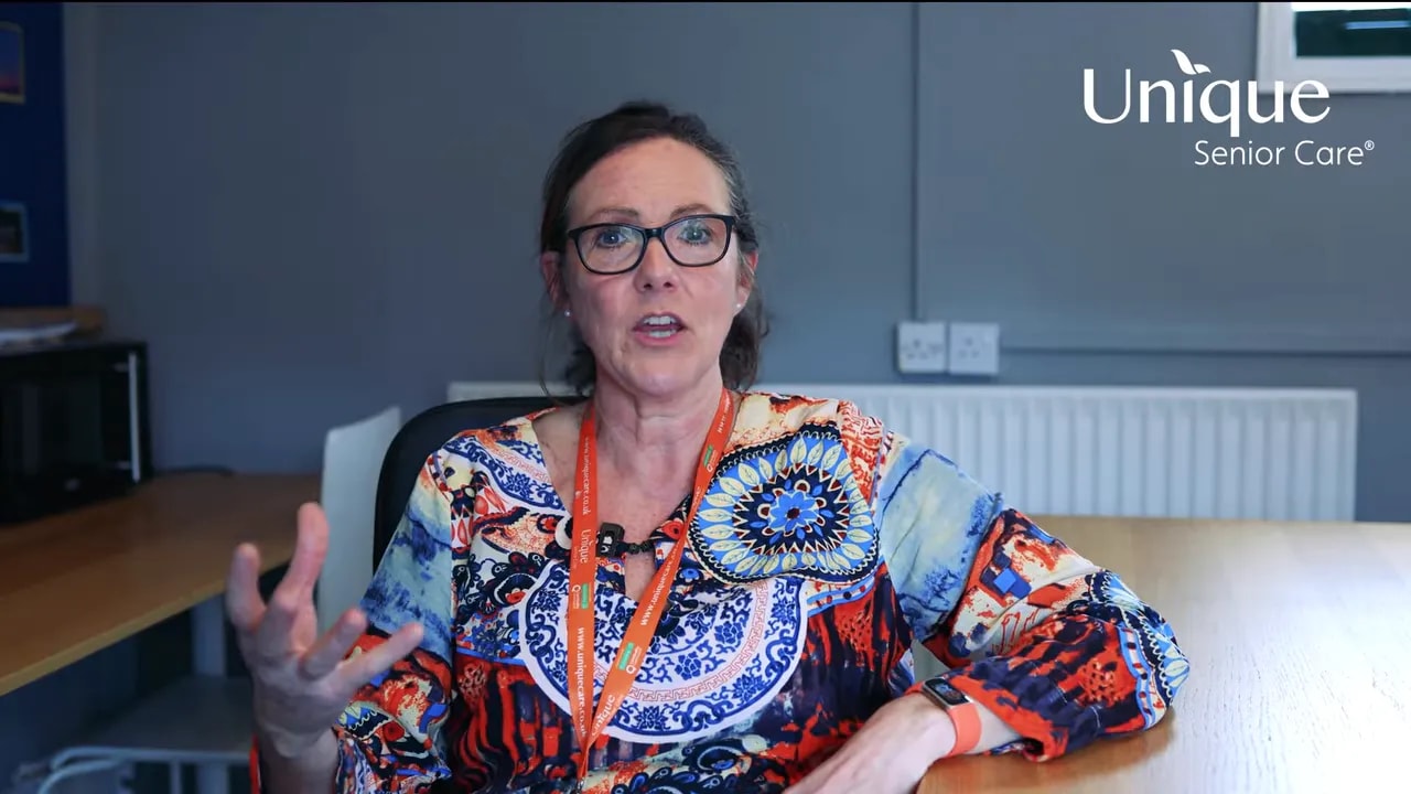 Nikki with open hand gestures explaining calm confidence in home care