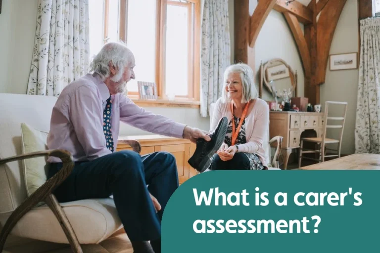 Older man and female care professional talking together in a living room.